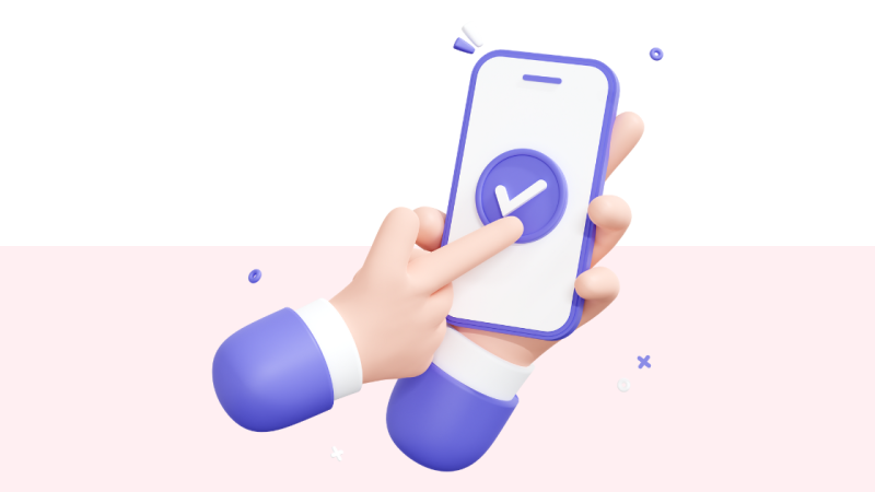 A person pointing to a checkmark on a cellphone screen.