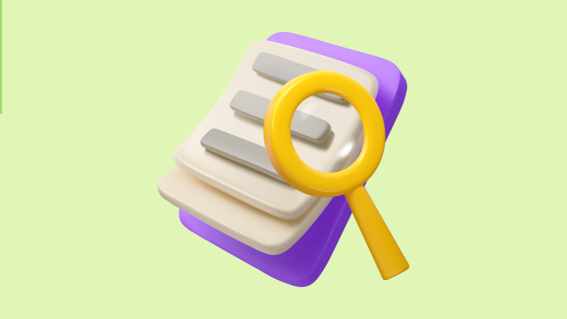 Magnifying glass on a clipboard graphic with the text